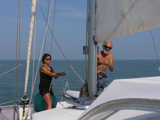 Claire tails while Jerry raises mainsail